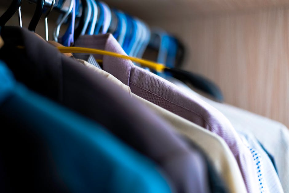 Shirts neatly hung on premium wooden hangers in a custom closet